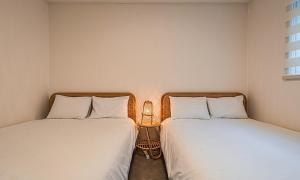 two beds sitting next to each other in a room at Chuncheon Bali 376 in Chuncheon +32 photos