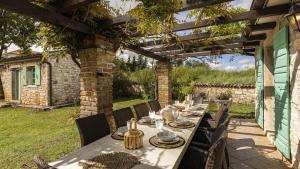 a table and chairs sitting under a pergola at Le Chateau B&B in Žikovići