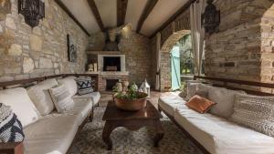 a living room with a couch and a table at Le Chateau B&B in Žikovići