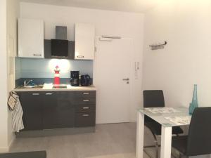 a kitchen with a table and a red lighthouse on the counter at Apartment Warnemünde 15 in Warnemünde