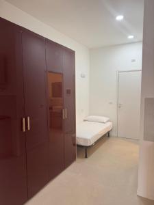 a bedroom with a bed and a large wooden cabinet at Duca d Aosta apartment 2 in Monfalcone +2 photos