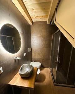 a bathroom with a toilet and a mirror at Be Local-Avola stay in Avola