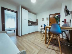 a kitchen and living room with a table and chairs at Gold Palace ***** in Ferrara