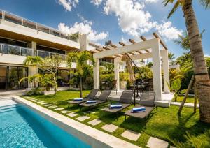 an exterior view of a villa with a swimming pool at Gandum Villa Complex - Luxury Boutique Stay Uluwatu in Uluwatu