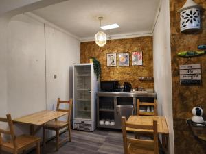 a kitchen with a table and a refrigerator at Lagoas in Tavira