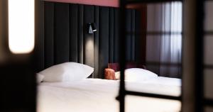 a bedroom with two beds with white sheets and pillows at Tallink Express Hotel in Tallinn