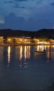 a boat sitting on the water at night at Sunshine in Olympiada