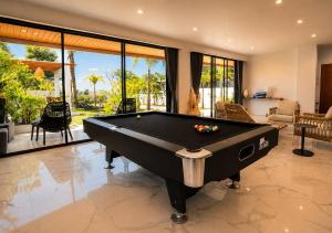 a living room with a pool table in a house at Gandum Villa Complex - Luxury Boutique Stay Uluwatu in Uluwatu