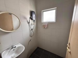 a bathroom with a sink and a mirror and a window at Above A Shoplot No Noise Worries 12Pax & FreeWiFi in Ipoh +16 photos