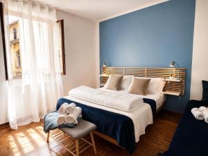 a bedroom with a large bed with a blue wall at Azzurra Beths House in Brenzone sul Garda