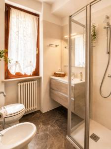 a bathroom with a shower and a toilet and a sink at Azzurra Beths House in Brenzone sul Garda +27 photos