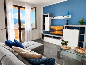 a living room with a couch and a television at Azzurra Beths House in Brenzone sul Garda