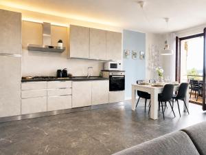 a kitchen with a table and chairs in a room at Azzurra Beths House in Brenzone sul Garda
