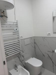 a bathroom with a white toilet and a sink at Duca d Aosta apartment 3 in Monfalcone