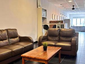 a living room with a couch and a coffee table at Above A Shoplot No Noise Worries 12Pax & FreeWiFi in Ipoh