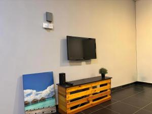 a flat screen tv hanging on a wall at Above A Shoplot No Noise Worries 12Pax & FreeWiFi in Ipoh