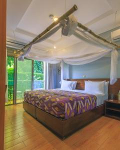 a bedroom with a bed with a canopy at Heaven Boutique Hotel in Kigali