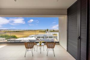 a balcony with a view of a boat at Lake View Suites in Paralimni