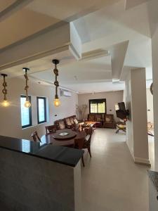 a living room with a table and a couch at Moussaoui house in Aïn Draham