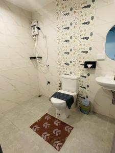 a bathroom with a toilet and a sink at The Camp in Kanchanaburi City