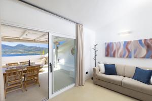 a living room with a couch and a table at MH Suites in Olbia +63 photos