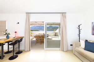a living room with a sliding glass door leading to a dining room at MH Suites in Olbia