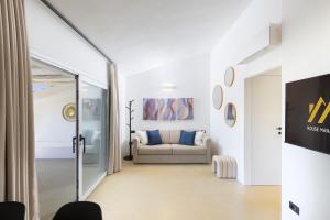 a living room with a couch and a window at MH Suites in Olbia