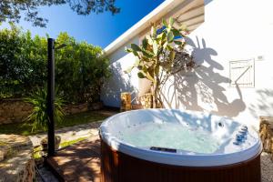 a hot tub in the backyard of a house at MH Suites in Olbia