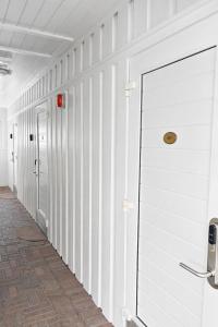 a hallway with white walls and white doors at Storebaug Motell in Moss