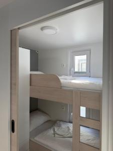 a room with two bunk beds and a window at JungleHouse - Floating House in Portorož