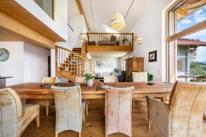 a dining room with a wooden table and chairs at Chalet Bergblick in Rimsting