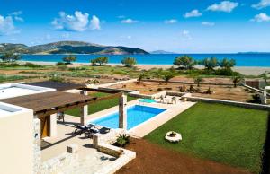an aerial view of a villa with a swimming pool and the ocean at Muses Beach Villas - Urania in Sitia