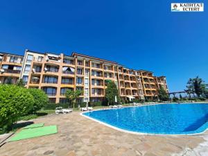 a large apartment building with a large swimming pool at Студио Ахелой in Aheloy