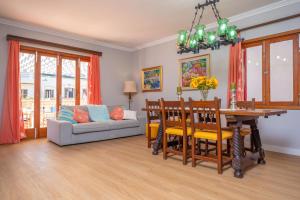 a living room with a table and a couch at Can Pons in Can Picafort