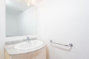 a white bathroom with a sink and a mirror at Can Pons in Can Picafort