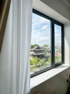 a window with a view of a building at Trang An Harmony Hotel in Ninh Binh