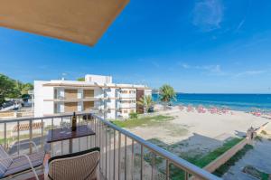 a balcony with a view of a beach and a building at Can Vesses in Alcudia