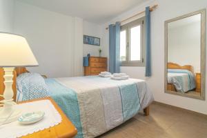 a bedroom with a bed and a mirror at Can Vesses in Alcudia