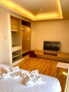 a bedroom with a bed with white bows on it at Adventure Studio Aonang in Ao Nang Beach