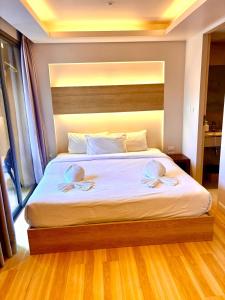 a bedroom with a large bed with two pillows on it at Adventure Studio Aonang in Ao Nang Beach