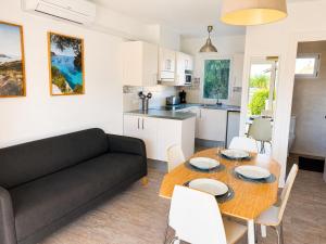 a living room with a couch and a table and chairs at Cala Porter Soleil & Mer Collection in Cala en Porter