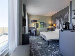 a hotel room with a bed and a window at Radisson Blu Metropol Helsingborg in Helsingborg