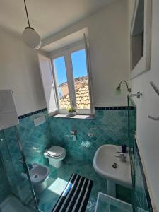 a bathroom with a sink and a toilet and a window at Brasca Amalfi Rosa Canina in Minori +22 photos