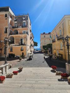 a city street with buildings and flowers in a courtyard at Brasca Amalfi Rosa Canina in Minori