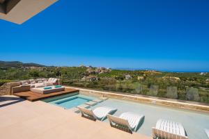a villa with a swimming pool with a view at Villa Reale - Wellness & Refined Living by etouri in Chania