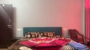 a bedroom with a bed with a blanket on it at Beas Zayaka - Hotel & Cafe in Pāndoh