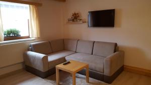 a living room with a couch and a table at Chalupa u Drába in Oščadnica