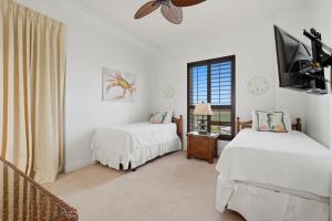 a bedroom with two beds and a tv and a window at La Playa 801 in Perdido Key +59 photos
