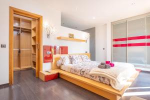 a bedroom with a bed with a wooden bench at Son Vigili in Campos +45 photos