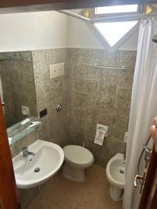 a bathroom with a sink and a toilet at Hotel Podgora Nuova Gestione in Rimini +19 photos